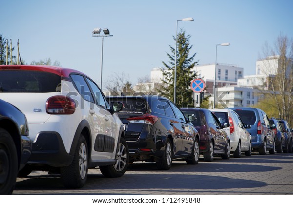 Warsaw, Poland - April 20th 2020: A\
long queue of cars for COVID-19 mobile testing drive-thru point by\
Polish DNA laboratory Diagnostyka Laboratoria\
Medyczne