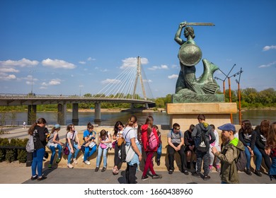 Warsaw, Poland - April 25, 2019: Group Of School Class Children On Sightseeing Tour At The Warsaw Mermaid By The Vistula River, City Landmark