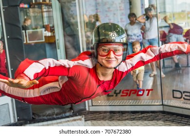 WARSAW, POLAND, AUGUST 5, 2017: Young woman enjoying flying in an aerodynamic tunnel. 