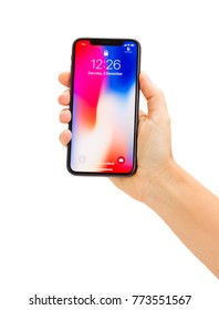 WARSAW, POLAND - DECEMBER 02: Hand Holding New Iphone X Mobile Phone Over White Background