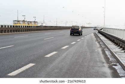 Warsaw, Poland - December 14, 2021: The North Bridge in Warsaw in winter. Winter weather conditions on the roads of the Polish capital. A wide road on the bridge, a tram in the background.