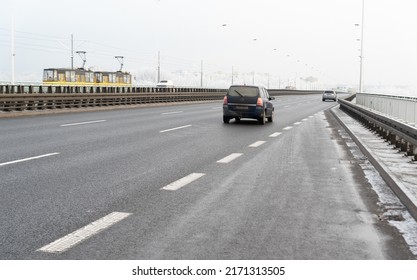 Warsaw, Poland - December 14, 2021: The North Bridge in Warsaw in winter. Winter weather conditions on the roads of the Polish capital. A wide road on the bridge, a tram in the background.