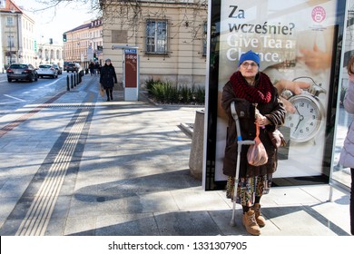 Warsaw Poland - February 25, 2019: Elderly Woman Waiting For A Bus At A Bus Stop In The Center