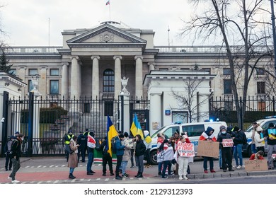 Warsaw, Poland - February 25, 2022: Group of people protesting against Russian invasion of Ukraine in front of Russian embassy in Warsaw city