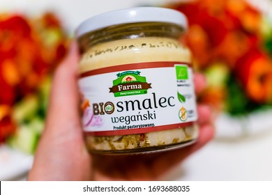 Warsaw, Poland - January 22, 2020: Hand Holding Organic Vegan Food Product Called Smalec, Pork Lard Substitute, Made By Primavika Local Company With Background Of Salads On Plate