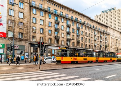 Warsaw, Poland - January 22, 2020: Crosswalk Zebra Crossing In Downtown Warszawa Street With People Waiting To Cross Jerozolimskie Road On Cloudy Winter Day With Streetcar