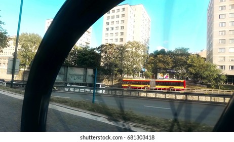 WARSAW, POLAND - JULY 18, 2017. City Street Traffic As Seen Behind Spinning Bike Wheel