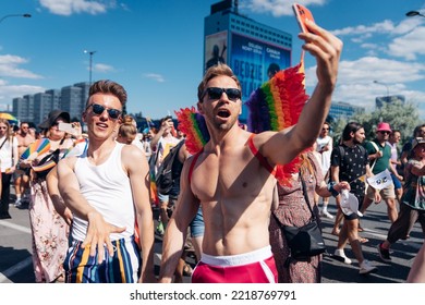 WARSAW, POLAND - Jun 25, 2022: Gay Men Dancing On The Street, Taking A Selfie During The Summer Day, Pride Parade, Warsaw 2022 