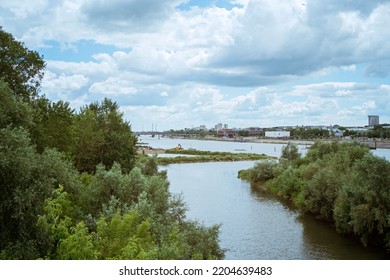 WARSAW, POLAND - JUNE 17, 2022, Cloudy Big City Day In Summer, Poland Tall Buildings Skyscrapers And Nature On The Horizon Over The Surface Of The Vistula River. City ​​panorama Beautiful Cityscape