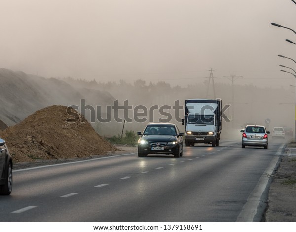 Warsaw, Poland -June 21, 2018: Strong wind\
grabs sand and reduce visibility on the\
road