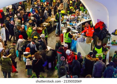 Warsaw, Poland - March 9, 2022: Volunteers help refugees from Ukraine at the railway station in Warsaw, Poland