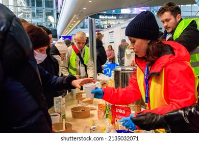 Warsaw, Poland - March 9, 2022: Volunteers help refugees from Ukraine at the railway station in Warsaw, Poland