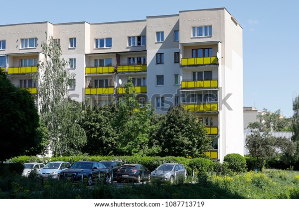 Warsaw, Poland - May 06, 2018: A multi-family\
building built of large prefabricated concrete slabs is in close\
proximity to the lush greenery. It is a housing estate under the\
local name of Goclaw
