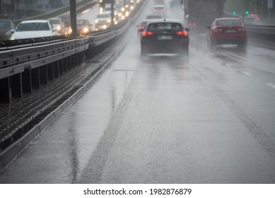 Warsaw, Poland - May 19, 2021: Cars In The Rain. Traffic In The City In Rainy Weather. Bad Road Conditions.