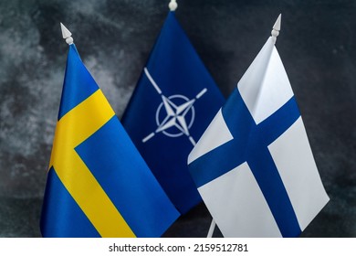 Warsaw, Poland. May 2022 - Flags Of Sweden And Finland Against The Background Of The NATO Symbol.