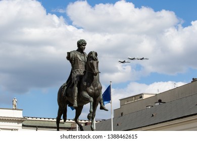 Warsaw, Poland - May 3, 2019: Military Aircraft Flying Over The Presidential Palace And A Monument To Prince Jozef Poniatowski