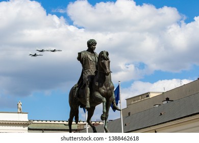 Warsaw, Poland - May 3, 2019: Military Aircraft Flying Over The Presidential Palace And A Monument To Prince Jozef Poniatowski