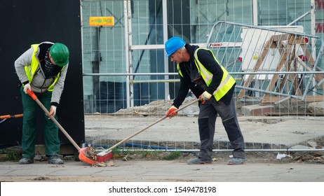 Warsaw, Poland - October 15, 2019: Cleaning Debris Workers In Helmets On Construction Site