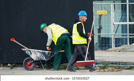 Warsaw, Poland - October 15, 2019: Cleaning Debris Workers In Helmets On Construction Site