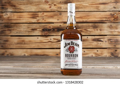 WARSAW, POLAND-DEC 20, 2018: A bottle of Jim Beam bourbon with filled glasses on a wooden background.