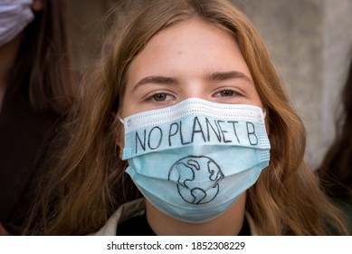 Warsaw, September 2020: Portrait Of A Girl Wearing Face Protective Mask At Youth Strike For Climate In Protest Of Climate Change Policy. No Planet B Sign