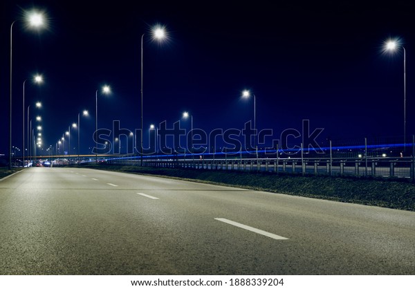 Warsaw street by\
night. Blue sky and\
lights