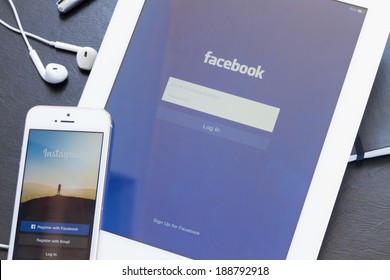 WARSZAWA, POLAND - APRIL 01, 2014: Instagram and Facebook apps on screen of Ipad 3 and Iphone 5s. Facebook is the largest social network in the world. It was founded in 2004 by Mark Zuckerberg .