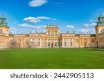 Warszawa, Poland - April 18, 2022: Focus on View of the central facade of the Royal Wilanow Palace in Warsaw, Poland. Spring in the park, magnolia blossoms