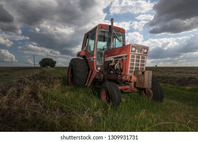 Warwick, Australia - January 10, 2017: An Old Red Tractor Sits In Farmland In Rural Queensland.