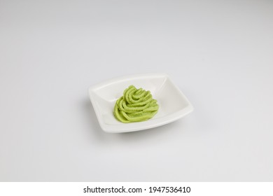 Wasabi is a Japanese seasoning. The appearance is creamy, yellowish green, with a pungent smell. The taste is spicy and tingles from the root. Or the large underground trunk of Wasabia (Wasabia japoni - Shutterstock ID 1947536410