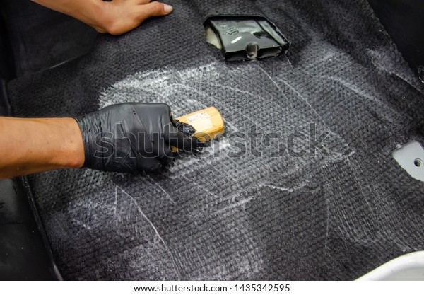 Wash the\
car carpet.Detailing on interior of modern car.Clean by using a\
brush and cleaning solution on the car\
carpet.