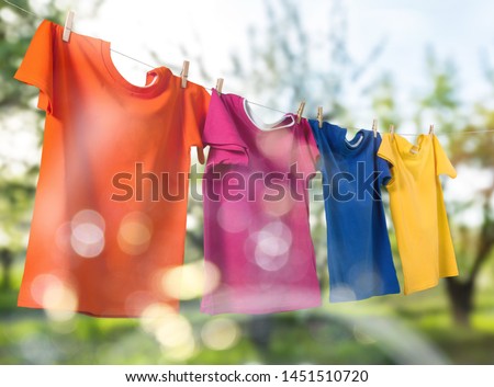 Wash clothes on a rope with clothespins on background