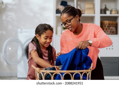 Wash Clothes In Washing Machine, Laundry Room, Bathroom, Two Women Spend Time Talking While Doing Household Chores, Mother Explains To Daughter, Teaches Her How To Sort Things By Color