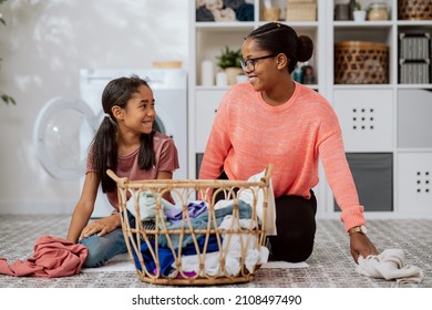 Wash Clothes In Washing Machine, Laundry Room, Bathroom, Two Women Spend Time Talking While Doing Household Chores, Mother Explains To Daughter, Teaches Her How To Sort Things By Color