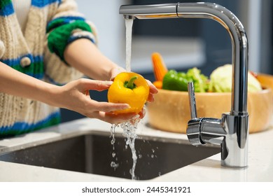 Wash vegetables - Close up woman hand. Fresh Vegetables washing in the kitchen. Clean food by water - Powered by Shutterstock