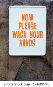 Wash Your Hands Sign On Stone Wall