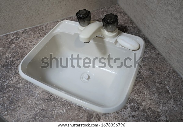 a washbasin\
and a water tank inside the\
caravan