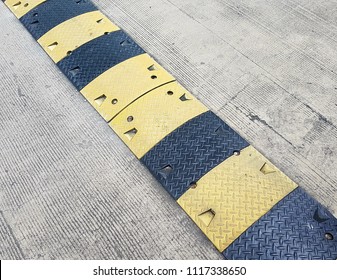 Washboard Road. Black And Yellow Speed Bump Or Speed Breaker. Transportation Concept.