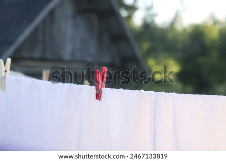 Washed clean textile and clothes drying on the rope outdoors. 