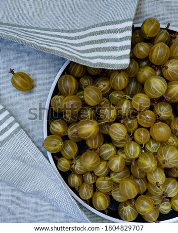 Image, Stock Photo Top view of organic gooseberries in a vintage bowl