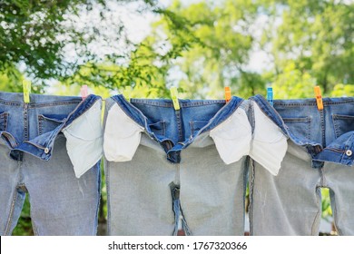 The Washed Jeans Hang On A Clothesline. Pockets Turned Inside Out. Drying Clothes On The Street. Life Style.