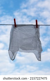 Washed Plastic Bag Hangs On A Rope. Reuse Concept.