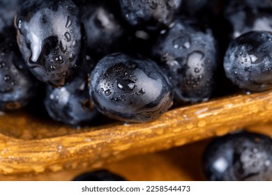 washed ripe black grapes covered with drops of water, harvested dark-colored grapes with drops of water - Shutterstock ID 2258544473