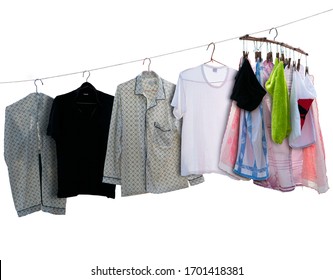 washed shirts and towels with coat hangers hanging to dry on clothesline, isolated on white
