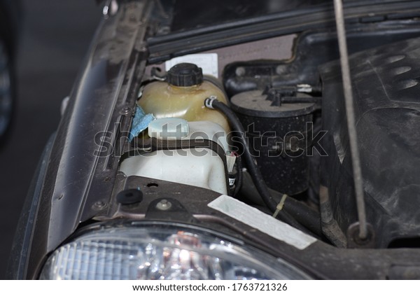 the washer fluid reservoir, coolant\
reservoir the engine cooling system. Under the hood of the car.\
Diagnostics of the car. Checking the liquid\
level.