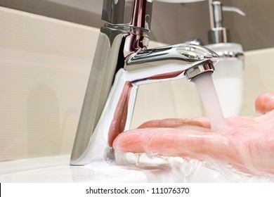 Washing arm  in sink bathroom.