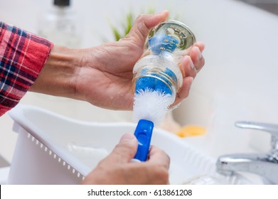 Washing Baby Bottles And Nipples With Soft Bottle Brush And Dishwashing Liquid