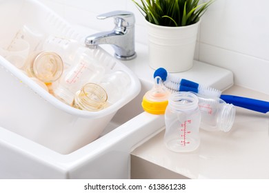 Washing Baby Bottles And Nipples With Soft Bottle Brush And Dishwashing Liquid