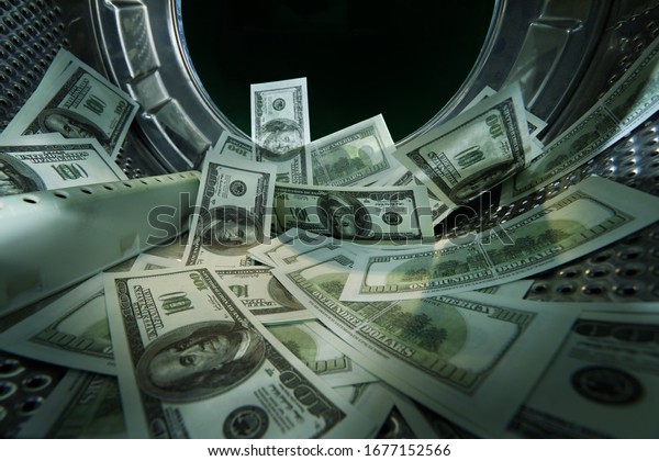 Washing banknotes in machine, money laundering,\
financial fraud concept