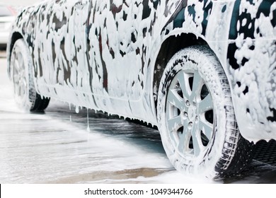 
Washing  black car with active foam